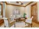 Comfortable office with hardwood floors, plenty of natural lighting and a writing desk at 6219 Woodlake Dr, Buford, GA 30518