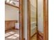Open pantry space through wood beam opening with white shelving at 6219 Woodlake Dr, Buford, GA 30518