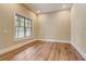 Neutral room with hardwood floors, large window, and ample natural light at 6219 Woodlake Dr, Buford, GA 30518