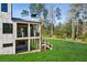 Backyard of the house featuring an outdoor patio, green grass, and mature trees at 225 River Valley Lot 5 Ct, Atlanta, GA 30328