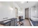 Bathroom with dual vanities, pendant lighting, and a freestanding tub in front of a marble tiled wall at 225 River Valley Lot 5 Ct, Atlanta, GA 30328