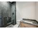 Modern bathroom featuring a stone shower with glass door and granite vanity at 225 River Valley Lot 5 Ct, Atlanta, GA 30328