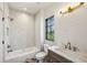 Bathroom boasting a tub with shower, marble countertop, and a bright window at 225 River Valley Lot 5 Ct, Atlanta, GA 30328