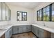 Stylish butler's pantry with grey cabinets, marble countertops, and a stainless steel sink at 225 River Valley Lot 5 Ct, Atlanta, GA 30328