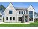Stunning modern home showcasing large black-framed windows and a well-manicured lawn on a sunny day at 225 River Valley Lot 5 Ct, Atlanta, GA 30328