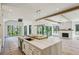 Open-concept kitchen with a large island and stainless steel sink, with white cabinets at 225 River Valley Lot 5 Ct, Atlanta, GA 30328