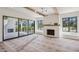 Spacious living room with a fireplace and expansive sliding doors leading to the outdoor patio at 225 River Valley Lot 5 Ct, Atlanta, GA 30328