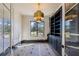 Office with a brass chandelier, floor to ceiling build-in shelving, and natural light from the black-framed window at 225 River Valley Lot 5 Ct, Atlanta, GA 30328