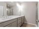 Bathroom with a dual sink vanity, large mirror, and modern fixtures at 88 Black Gum Ln # 43, Auburn, GA 30011