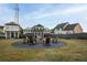 Community fire pit area with Adirondack chairs nestled in a landscaped common yard among modern homes at 88 Black Gum Ln # 43, Auburn, GA 30011