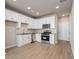 Modern kitchen with white cabinetry, stainless steel appliances, and wood-look floors for a clean and bright space at 88 Black Gum Ln # 43, Auburn, GA 30011