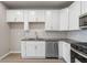 Kitchen featuring white cabinets, stainless steel appliances, gray countertops, and light tile backsplash at 88 Black Gum Ln # 43, Auburn, GA 30011