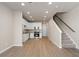 Open-concept kitchen featuring white cabinets, stainless steel appliances, and light floors flowing into living area at 88 Black Gum Ln # 43, Auburn, GA 30011
