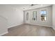 Bright living space with wood-look floors, multiple windows, and a door with glass panels for ample natural light at 88 Black Gum Ln # 43, Auburn, GA 30011