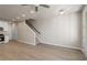 Open-concept living space showcasing wood-look floors, a staircase, and adjacent kitchen with white cabinets at 88 Black Gum Ln # 43, Auburn, GA 30011