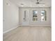 Bright living space with wood-look floors, multiple windows, and a door with glass panels for ample natural light at 88 Black Gum Ln # 43, Auburn, GA 30011