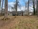 Backyard view of home featuring mature trees and wooded area at 130 Ashley Oaks Dr, Mcdonough, GA 30253
