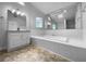 A well-lit bathroom with large tub, ample counter space, and large mirror at 130 Ashley Oaks Dr, Mcdonough, GA 30253