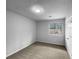 This carpeted bedroom features a window to a tree, neutral paint, and a door at 130 Ashley Oaks Dr, Mcdonough, GA 30253