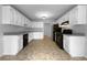 Bright kitchen with white cabinets, granite countertops, and modern black appliances at 130 Ashley Oaks Dr, Mcdonough, GA 30253