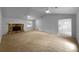 Large living room featuring a stone fireplace, ceiling fans, and an open layout at 130 Ashley Oaks Dr, Mcdonough, GA 30253