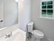 Bathroom featuring a new toilet, sink and faucet at 225 Woodfield Ct, Mcdonough, GA 30253