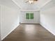 Bedroom featuring hardwood floors, a ceiling fan and a bright window at 225 Woodfield Ct, Mcdonough, GA 30253