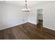 Dining room featuring hardwood floors, white walls and a modern chandelier at 225 Woodfield Ct, Mcdonough, GA 30253