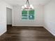 Bright dining room with modern lighting, fresh paint and hardwood style laminate flooring at 225 Woodfield Ct, Mcdonough, GA 30253