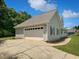 Exterior view featuring a two-car garage and driveway at 225 Woodfield Ct, Mcdonough, GA 30253