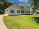 Charming home featuring a front porch, lush lawn, and mature trees at 225 Woodfield Ct, Mcdonough, GA 30253
