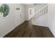 Bright foyer with hardwood floors, a stained glass window and white staircase at 225 Woodfield Ct, Mcdonough, GA 30253