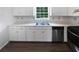 Kitchen featuring white cabinets, stainless steel appliances and a double sink at 225 Woodfield Ct, Mcdonough, GA 30253