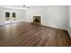 Spacious living room with hardwood floors and a fireplace, bathed in natural light at 225 Woodfield Ct, Mcdonough, GA 30253