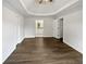 Sunlit main bedroom with neutral walls and dark floors leading to ensuite at 225 Woodfield Ct, Mcdonough, GA 30253