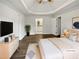 Inviting main bedroom with tray ceiling and sleek furniture; walk in to the attached bath at 225 Woodfield Ct, Mcdonough, GA 30253