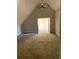 Attic space featuring a vaulted ceiling, carpet floors, and a view to the house below at 168 Harmony Grove Rd, Lilburn, GA 30047