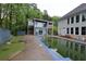 Back exterior view of two houses and pool featuring a modern design at 168 Harmony Grove Rd, Lilburn, GA 30047