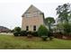 Image shows side yard with lush green grass, mature trees, and a well-manicured lawn at 168 Harmony Grove Rd, Lilburn, GA 30047