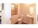 Small powder room with pedestal sink, toilet, and dark hardwood floors at 3711 Chevington Se Ct, Atlanta, GA 30354