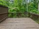 Spacious wood back deck with views of a lush green forest at 2708 Parkway Trl, Lithonia, GA 30058