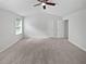 Large bedroom features neutral walls, a ceiling fan, and carpeted floors at 2708 Parkway Trl, Lithonia, GA 30058