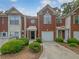 Brick townhome with a one-car garage and well-maintained landscaping at 2708 Parkway Trl, Lithonia, GA 30058