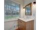 Bright bathroom features a modern vanity with a light countertop and a window offering a view of the outdoors at 3159 Nursery Se Rd, Smyrna, GA 30082