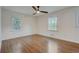 Bright bedroom with hardwood floors, two windows, and a neutral color palette at 3159 Nursery Se Rd, Smyrna, GA 30082