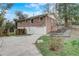 Rear view of brick home featuring a walkout basement, garage, and driveway with landscaping at 3159 Nursery Se Rd, Smyrna, GA 30082