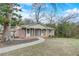 Charming brick home with a well-manicured lawn and inviting front porch, perfect for enjoying the outdoors at 3159 Nursery Se Rd, Smyrna, GA 30082
