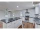 Open concept kitchen with stainless steel appliances, an island, hardwood floors, and view of the living space at 3159 Nursery Se Rd, Smyrna, GA 30082