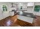 Updated kitchen with granite countertops, stainless appliances, island, and white cabinets at 3159 Nursery Se Rd, Smyrna, GA 30082