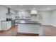 Kitchen features an island, stainless steel appliances, subway tile backsplash, and hardwood floors at 3159 Nursery Se Rd, Smyrna, GA 30082
